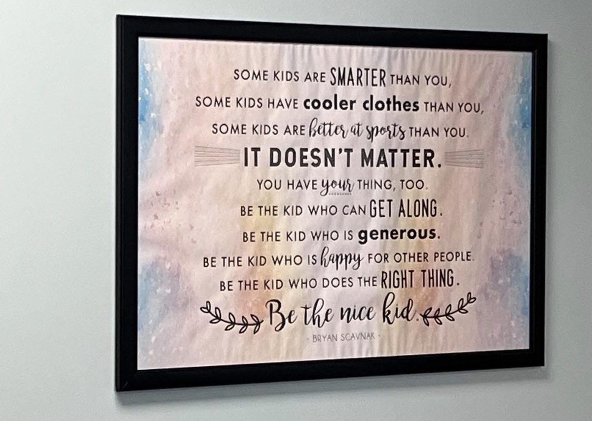 Be the nice kid poster by Bryan Scavnak in a school hallway