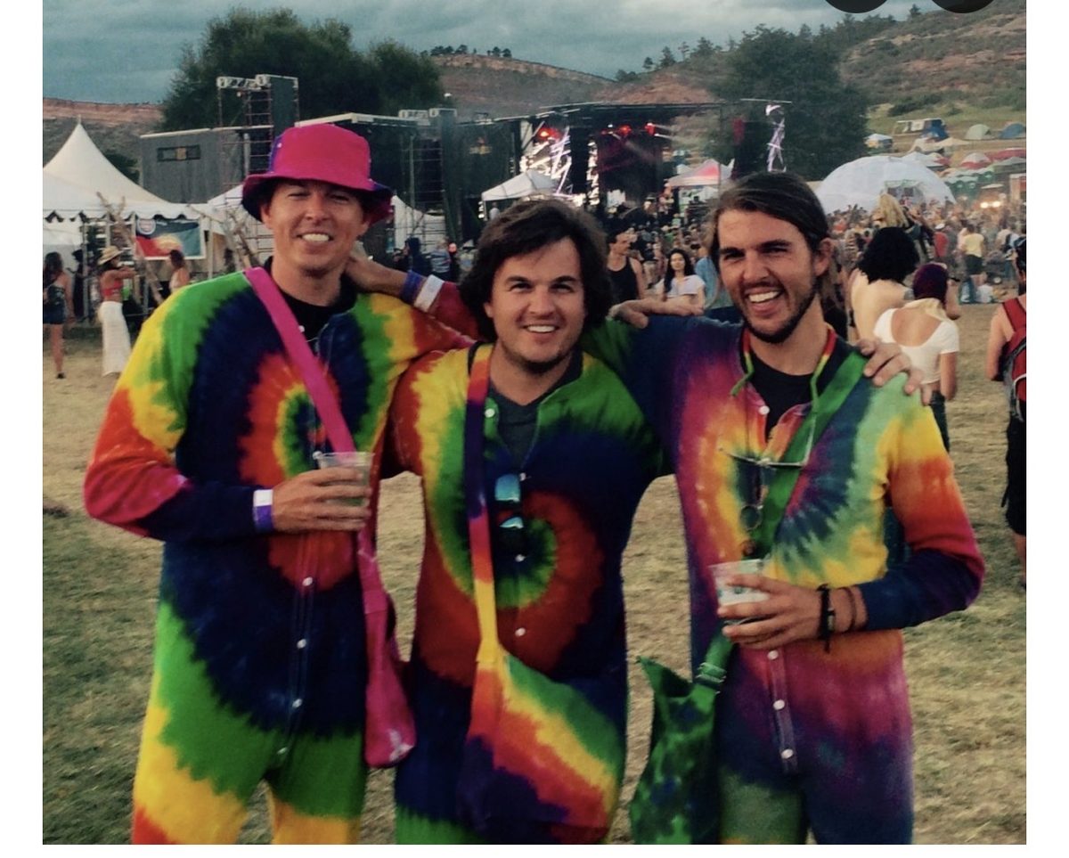Chip with his brothers Colin and Austin in tie-dye onesies at Arise Music Festival